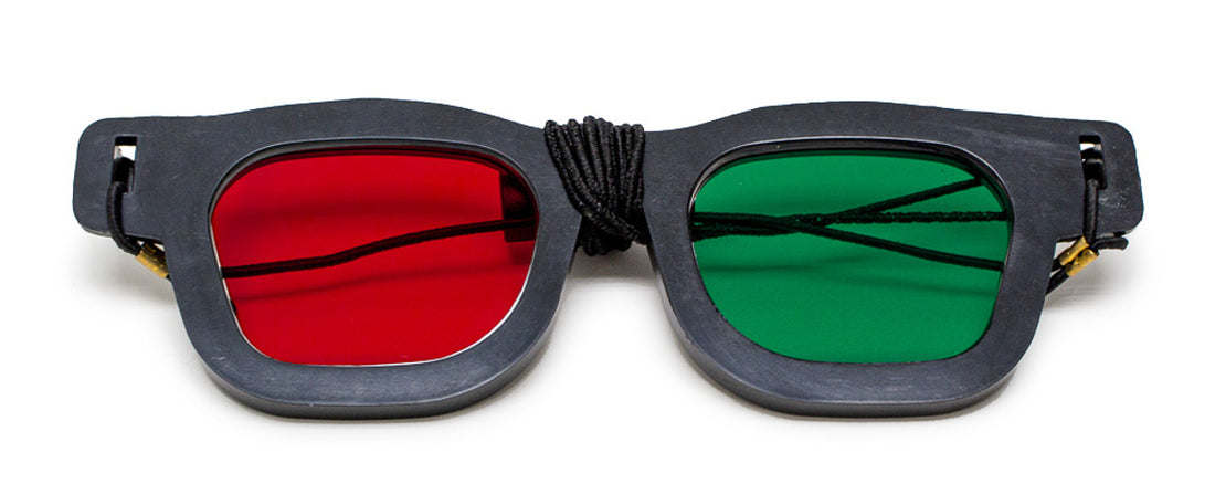Red Green vision therapy goggles on a white background
